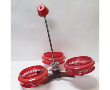 A retro three branch ceiling pendant light fitting with red decorative glass shades