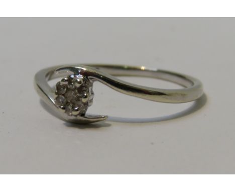 An eight stone diamond 9 carat white gold cluster ring, finger size K, 1.2g gross