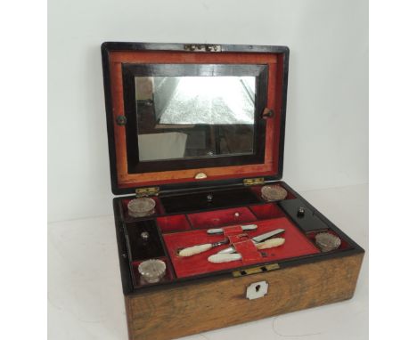 A Victorian rosewood ladies dressing case with fitted interior & lift-out tray, containing bottles, mother of pearl handled p