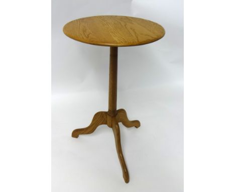 An modern oak occasional tripod table.