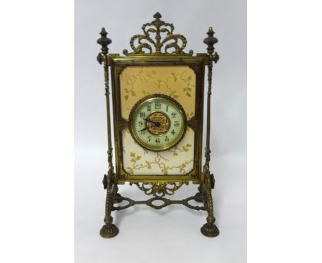 A French porcelain and brass mantle clock with key, 38cm tall.