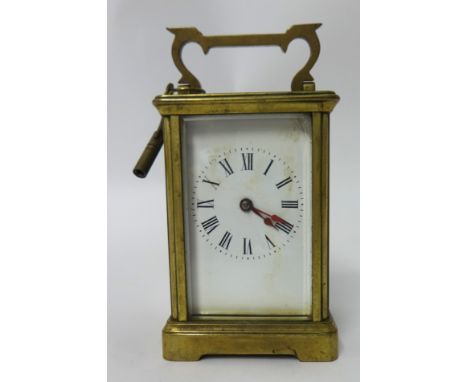 A brass cased carriage clock with key, 15cm tall