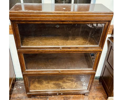 A 20th century oak glazed Globe Wernicke bookcase, circa 1947, three tier and makers name on the back.