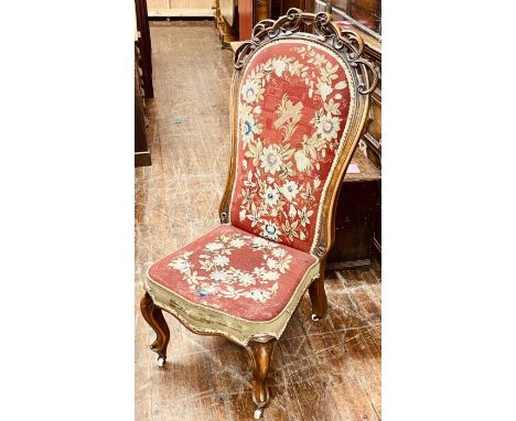 An early Victorian walnut drawing room chair, circa 1850, scrolling carved top, tapestry stuffed back and seat, raised on cab