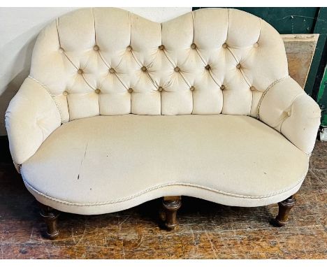 A Victorian kidney shaped button back bedroom sofa, later upholstered, raised on turned tapered oak supports.