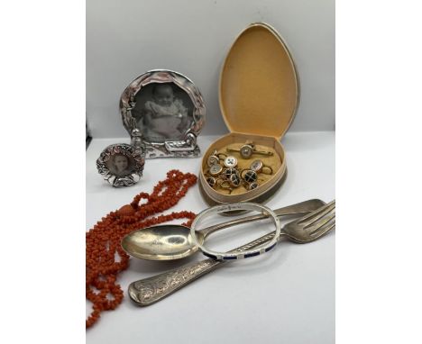 A selection of jewellery and collectables comprising two silver plated pewter photo frames, a coral necklace, a mother of pea