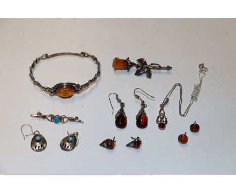 A box containing 925 silver and white metal jewellery, some set with amber to include bangle; brooch; ear-rings etc