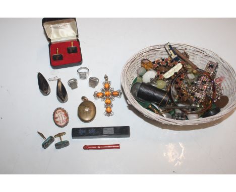 A basket containing various costume jewellery, caddy spoon, small glass measure  