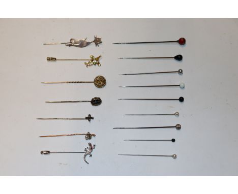 A collection of yellow metal and other stick pins