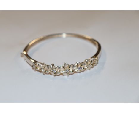 A sterling silver flower fronted bangle, approx. 13gms