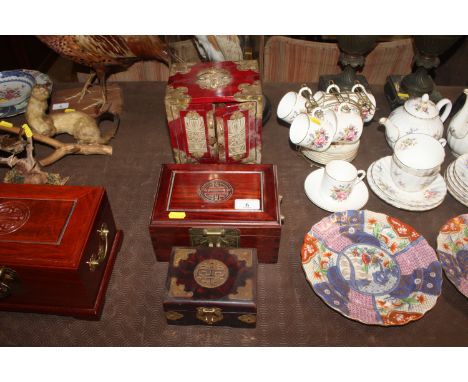 An Oriental red lacquered trinket cabinet with brass mounts; a Cherrywood trinket box and a faux tortoiseshell similar 