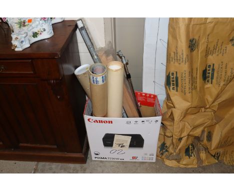 A box containing various rolled posters and prints; a tripod etc.