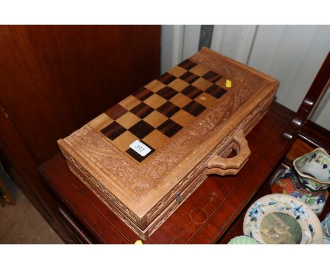 A carved chess board and backgammon set