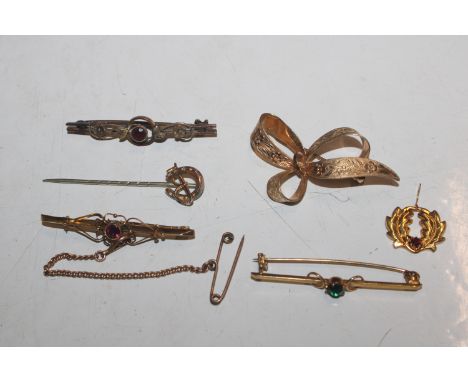 A yellow metal bow brooch; a 9ct gold bar brooch set with coloured stone; two other bar brooches; silver gilt pendant and a s