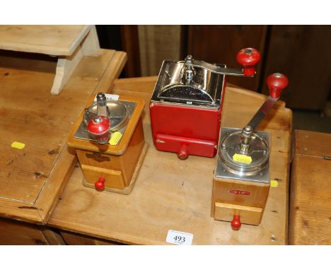 Three vintage coffee grinders to include Kym
