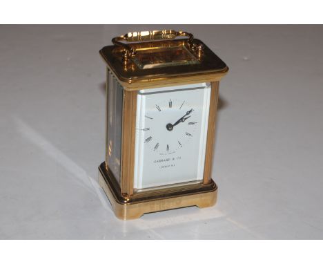 A Garrod & Co. of London brass cased carriage clock with presentation plaque tot he reverse 