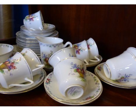 A Part 'Shelly' Hampton Court Tea Set, comprising nine cups, twelve saucers, twelve tea plates, two sandwich plates, slop bow