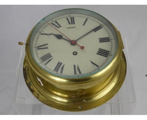An English Made Brass Marine Clock, white enamel dial.