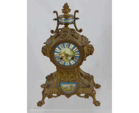 A French Style Brass Chiming Mantel Clock, nr 8328 to movement, with Sevres style porcelain face having lion mask motif to to