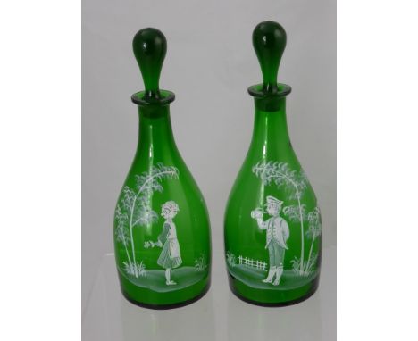A Pair of Green Glass 'Mary Gregory' Decanters and Stoppers, with white enamel decoration, approx 30 cms