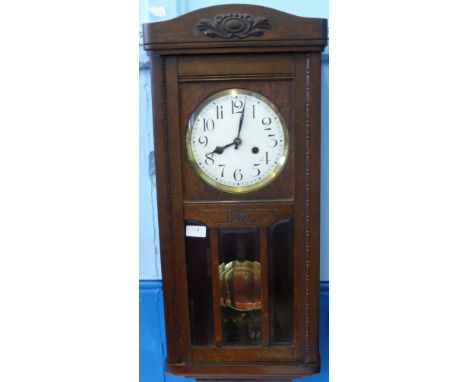 An Oak Cased 3/4 Westminster Wall Clock, with brass and enamel dial, 77 x 32 cms.