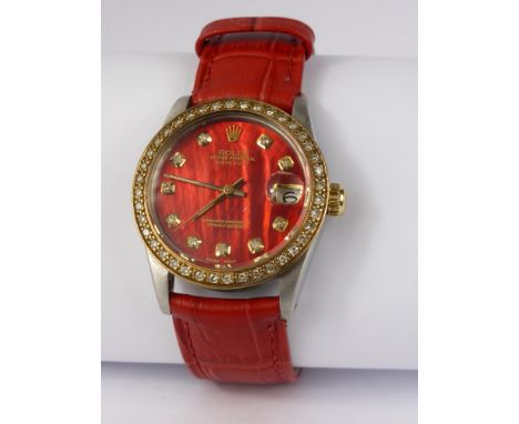 A Lady's Vintage Stainless Steel Rolex Oyster with Diamond Bezel, the watch having a red mother of pearl face with diamond ma