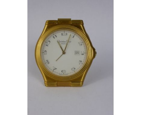A Christian Dior Travel Alarm Clock, the clock having a gilt finish with date aperture, case nr 372302 01284 with original sl