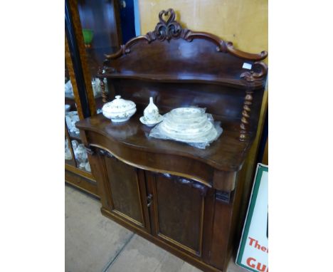 A Mahogany Victorian Chiffonier, serpentine front with carved upper shelf on barley twist supports, single cutlery drawer wit