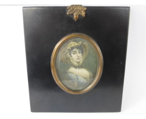 An Antique Portrait Miniature, painted on ivory, depicting a young woman, in an ebonized frame, signed Orlando.