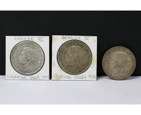 A collection of three British pre decimal silver full crown coins to include King George V and King George VI examples. 