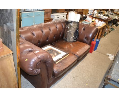 A brown leather Chesterfield two seater sofa