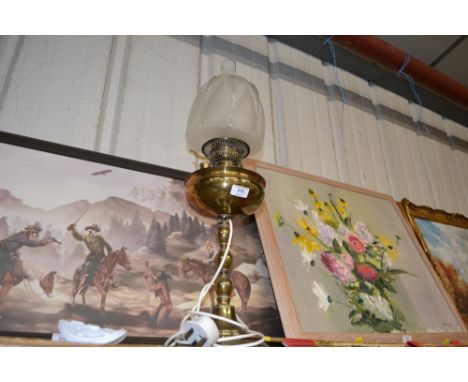 A brass table lamp with frosted glass shade converted to electricity 