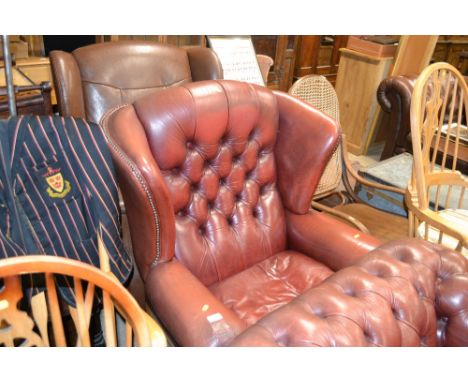 A red leather button back Chesterfield wing back armchair