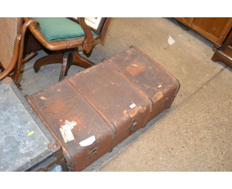 A wooden bound trunk containing curtains and textiles 
