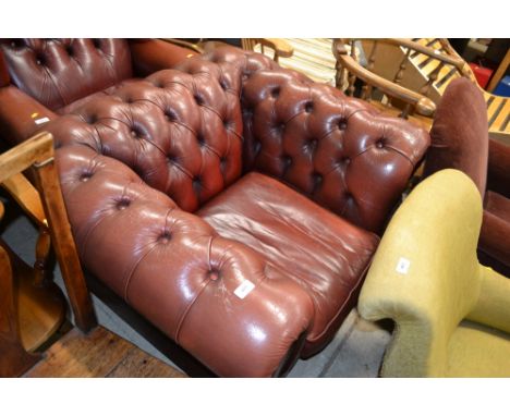 A red leather button back Chesterfield armchair 