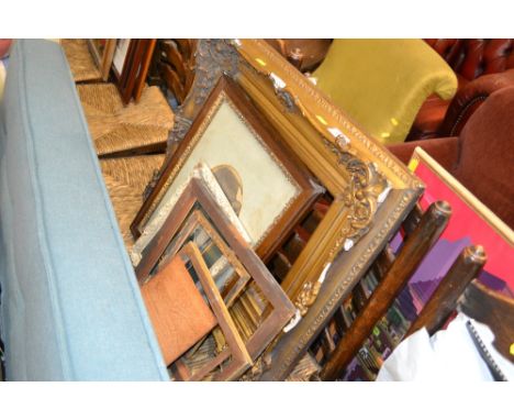An ornate gilt picture frame together with a Victorian black and white portrait photograph, and various other frames 