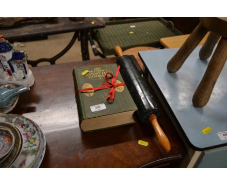 An edition of Mrs Beeton's Everyday Cookery and a rolling pin 