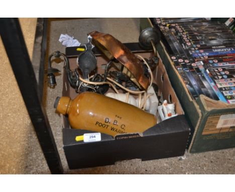 A box containing a stoneware foot warmer, a alabaster table lamp base, a copper mould and light fittings etc. 