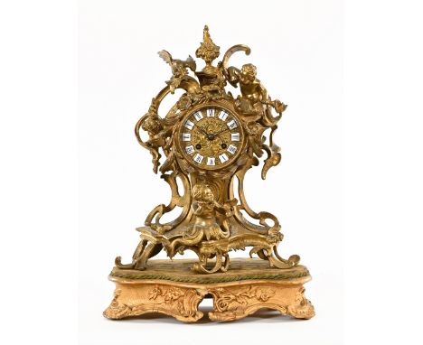 A continental ormolu mounted mantle clock, in the Rococo style, eight day striking movement, on a gilt base.  Height includin