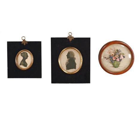 Two oval 19th century silhouette portrait miniatures, and a dried flower picture. CONDITION REPORT: The information to the re