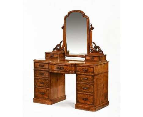 A Victorian walnut dressing table, with mirrored superstructure, bow front and four drawers to each side raised on a plinth. 