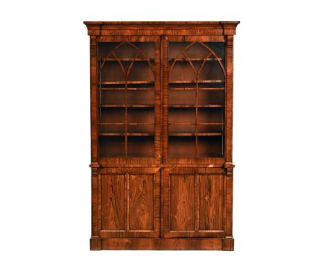 A 19th century rosewood bookcase, with detachable moulded cornice above a pair of glazed doors with wooden astragals, the bas