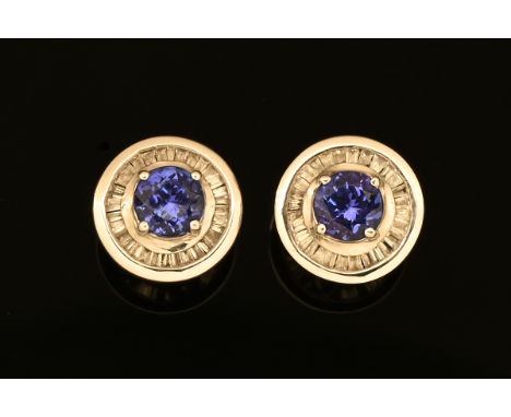 A pair of 18 ct white gold tanzanite and diamond set screw back stud earrings.  Diameter +/- 10 mm stamped 18 k, gross weight