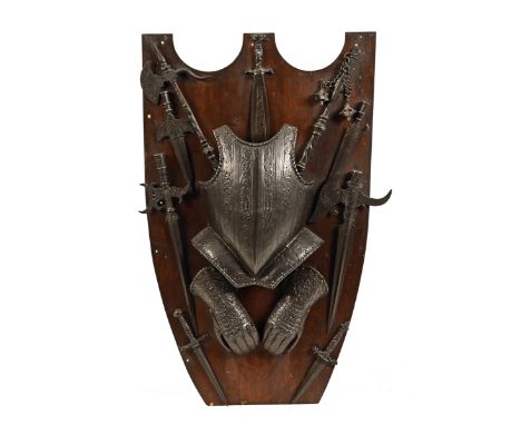 A collection of 20th century medieval style weaponry, to include breastplate, gauntlets and an array of axes, daggers and mac
