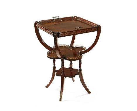 An Edwardian mahogany table with detachable tray top, the shaped shelf with brass gallery and raised on sabre legs terminatin