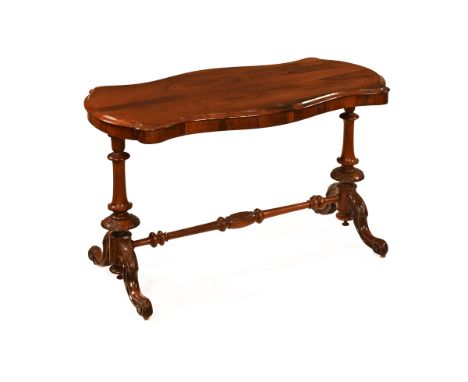 A Victorian rosewood stretcher table, of shaped outline with turned columns and downswept legs terminating in castors.  Heigh