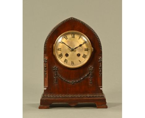 An Edwardian mahogany mitre topped mantle clock, with two train striking movement.  Height 31 cm, complete with key and pendu