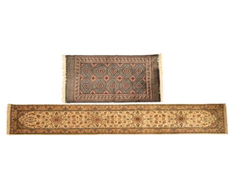 A Sino Persian runner, with floral patterns and light ground colours.  425 cm x 28 cm, together with a Persian rug with blue 
