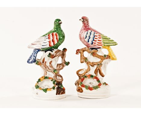 A pair of 19th century Staffordshire pigeons, on branch and nest with eggs.  Each height 23 cm. CONDITION REPORT: Both the pi