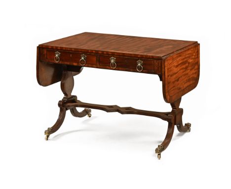 A Regency mahogany and rosewood banded sofa table, with frieze drawers to either side with brass drop handles and raised on s